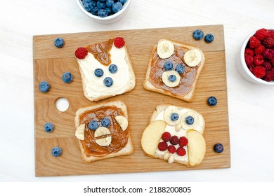 Funny Cute Bear,monkey,fox,owl Faces Sandwich Toast Bread With Peanut Butter,banana,blueberry,raspberry,milk. Kids Childrens Baby's Sweet Dessert Healthy Breakfast Lunch Food Art,close Up,top View.