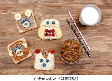 Funny Cute Bear,monkey,fox,owl Faces Sandwich Toast Bread With Peanut Butter,banana,blueberry,raspberry,milk. Kids Childrens Baby's Sweet Dessert Healthy Breakfast Lunch Food Art,close Up,top View.