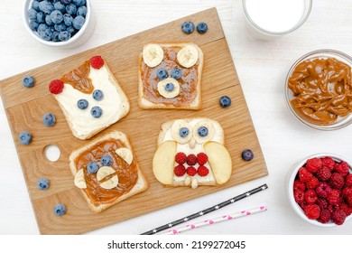 Funny Cute Bear,monkey,fox,owl Faces Sandwich Toast Bread With Peanut Butter,banana,blueberry,raspberry,milk. Kids Childrens Baby's Sweet Dessert Healthy Breakfast Lunch Food Art,close Up,top View.