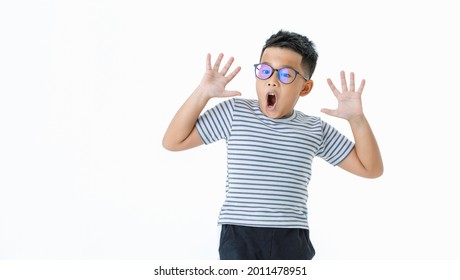 Funny cutout portrait of young healthy Asian boy wearing glasses and casual horizontal striped shirt shout out loud with hands covering face as shocked, surprising, exciting on unexpected opportunity - Powered by Shutterstock