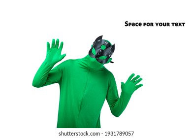 Funny Dancing Guy In Chroma Key Green Screen Body Suit And Sexy Cat Mask. Cheerful Male Cross Dressing Person Raising His Hands. Man A Colorful Green Body Suit And Leather Cat Mask, Carnival Mask