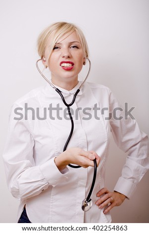 funny doctor with stethoscope, smiling blond woman medical equipment showing on white background