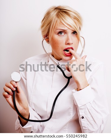 funny doctor with stethoscope, smiling blond woman medical equipment showing on white background