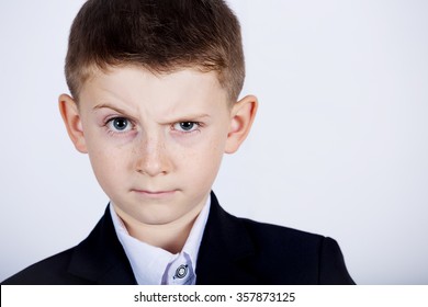 Funny emotion of  little boy young man with a raised eyebrow wearing costume with braces.Happy little boy over white background.Smiling, Happy, Joyful beautiful little boy , looking at camera.