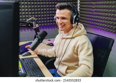 funny and emotional radio host with headphones on fun live streaming, reading news and messages from radio listeners into a studio microphone on a radio station