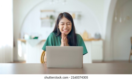 Funny euphoric young asian woman celebrating winning or getting ecommerce shopping offer on computer laptop. Excited happy girl winner looking at notebook celebrating success - Shutterstock ID 2160374305