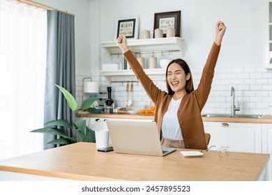 Funny euphoric young asian woman celebrating winning or getting ecommerce shopping offer on computer laptop. Excited happy girl winner looking at notebook celebrating success - Powered by Shutterstock