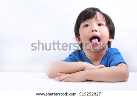 Funny expression of a little Asian boy isolated on white background
