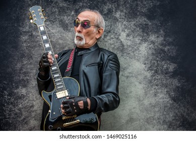 Funny And Extravagant Senior Man Posing On Colored Background - Youthful Old Man In The Sixties Having Fun And Partying