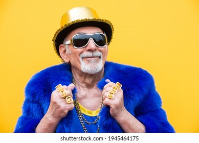 Funny And Extravagant Senior Man Posing On Colored Background - Youthful Old Man In The Sixties Having Fun And Partying