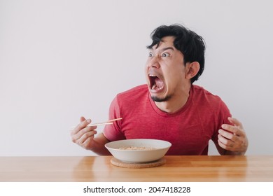 Funny Face Of Asian Man Eat Very Hot And Spicy Instant Noodle.