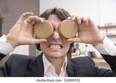 Funny face of a businessman instead coasters Eye