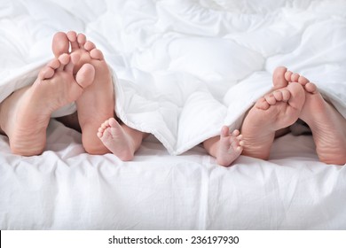 Funny Family Feet Under The Blanket