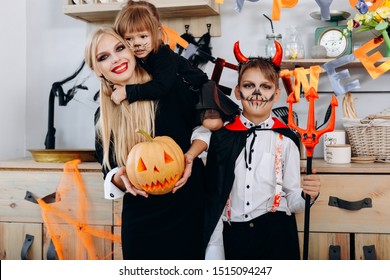 Funny Family In The Kitchen Standing  In Fancy Dress And Looking At The Camera - Halloween Concept