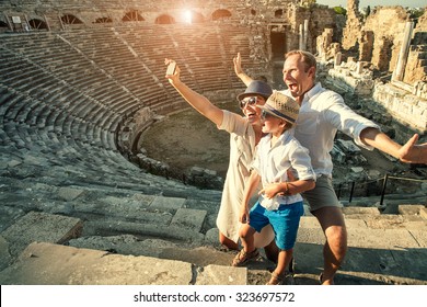 Funny family take a self photo in amphitheater building.Side,Turkey