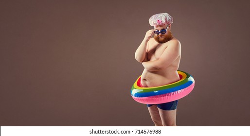Funny fat bearded man in a swimsuit.