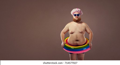 Funny fat bearded man in a swimsuit.