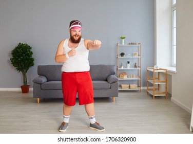 Funny Fat Boxer In Sportswear Is Boxing In The Room.