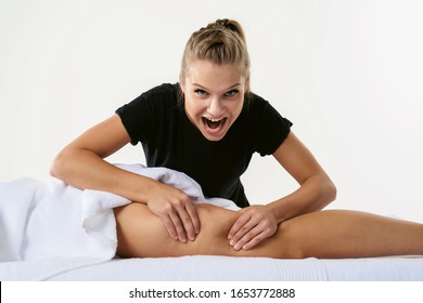 Funny fat burning concept. Anti cellulite massage for young woman in beauty salon. Masseur at work in beauty salon wellness center. Perfect skin