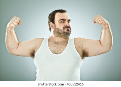 Funny Fat Macho Man Isolated On Grey