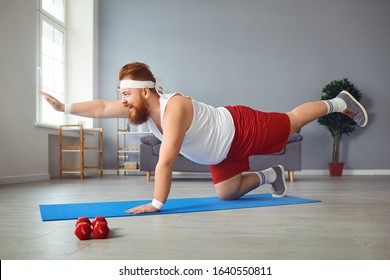 Funny Fat Man Doing Yoga Exercises In The Room.