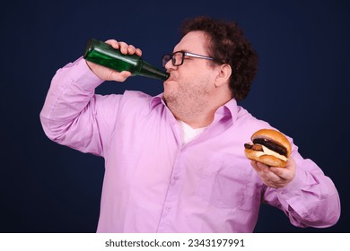 Funny fat man drinking beer and eating burger.