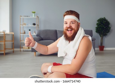 Funny Fat Man Raised His Thumb Up While Sitting On The Floor Smiling On The Floor At Home. The Concept Of Losing Weight Sports Exercise Healthy Lifestyle.