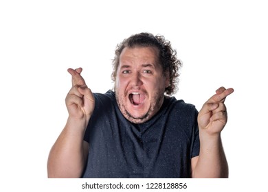 Funny fat man waiting for special moment and crossing fingers. Be happy, win in lottery or make a wish - Shutterstock ID 1228128856