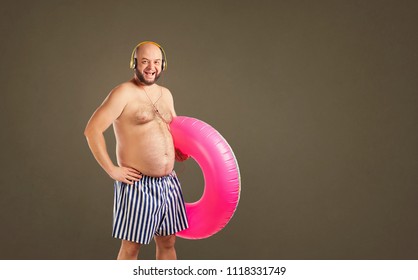 Funny Fat Naked Man With A Circle For Swimming In Summer.