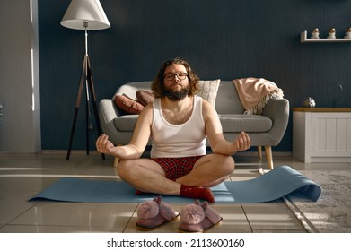Funny fatty man meditating practicing home yoga