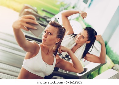 Funny Female Friends Taking Selfie After Workout In The Gym.