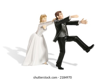 A Funny Figurine Of A Groom Having Second Thought At His Wedding