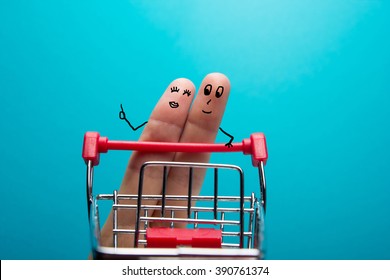 Funny Fingers Shopping At Supermarket With Red Cart Trolley On Blue Background