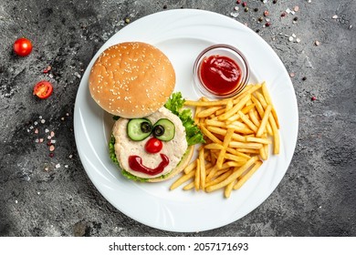 funny food face tasty burger with french fries, ketchup, Baby menu of the restaurant.