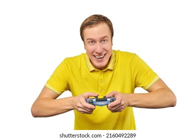 Funny gamer man with gamepad in yellow T-shirt isolated on white background. Cheerful young guy holding joy stick and playing videogames on TV, excited video game player concept