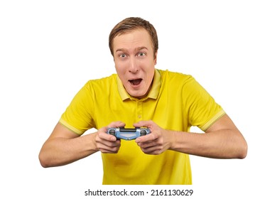 Funny gamer man with gamepad in yellow T-shirt isolated on white background. Cheerful young guy holding joy stick and playing videogames on TV, excited video game player concept