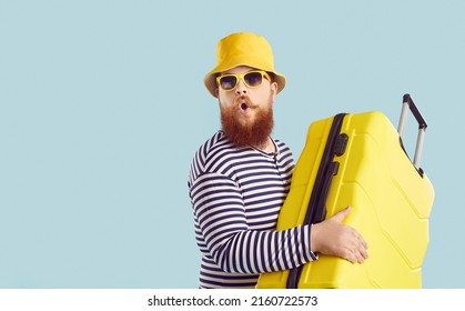 Funny ginger guy goes on vacation. Plus size man in bucket hat, sunglasses and striped swimwear holding yellow suitcase and looking at something with surprised face expression. Travel, holiday concept