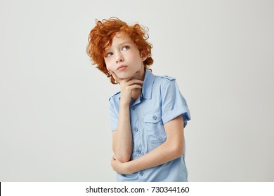 Funny Ginger Little Boy With Wavy Hair And Freckles Dreamy Looking Aside Trying To Remember If He Did Homework For School