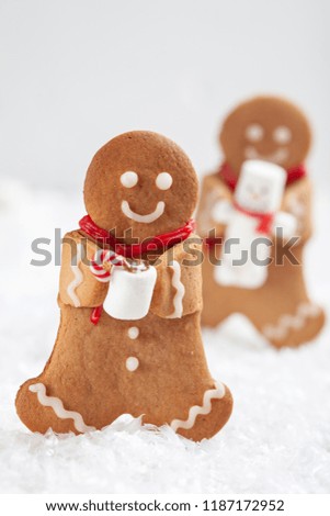 Funny Gingerbread cookie men with tiny marshmallow snowman