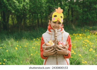 Funny girl with eggs basket and with a chicken mask on Easter egg hunt in sunny spring garden. Hunting for Easter eggs - Powered by Shutterstock