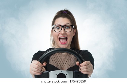 Funny girl in glasses with car wheel and white smoke, auto concept 