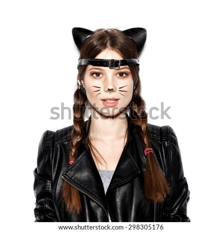 Funny girl represents as small cat.  Woman  with bright makeup hairstyle of girl with leather cat ears having fun. On white background not isolated