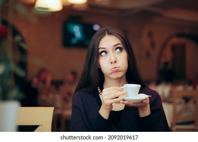 
				Funny Girlfriend Holding a Cup of Coffee Waiting in the Restaurant. Unhappy girlfriend waiting for her date feeling awkward and impatient
				