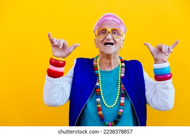 Funny grandmother portraits. 80s style outfit. trapstar dance on colored backgrounds. Concept about seniority and old people