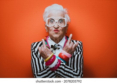 Funny grandmother portraits. Senior old woman dressing elegant for a special event. granny fashion model on colored backgrounds - Shutterstock ID 2078203792