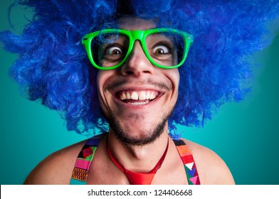 Funny guy naked with blue wig and red tie on blue background