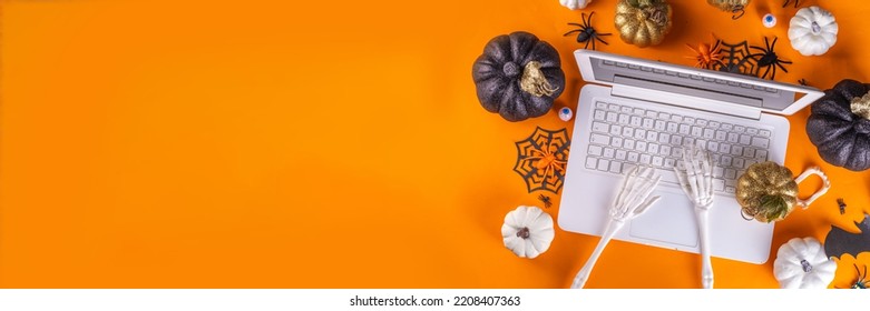 Funny Halloween Workplace With Laptop Flat Lay. Office Corporation Halloween Party Invitation, Blogger Autumn Holiday Background. White Laptop With Halloween Party Decor, Orange Background Top View