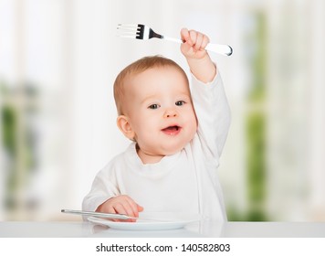 Funny Happy Baby With A Knife And Fork Eating Food