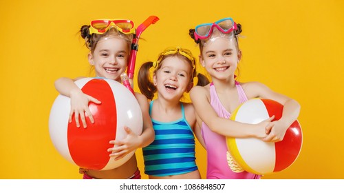 funny funny happy children  jumping in swimsuit and swimming glasses jumping on colored background