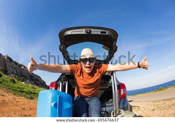 Funny happy man going on summer vacation. Car\
travel concept